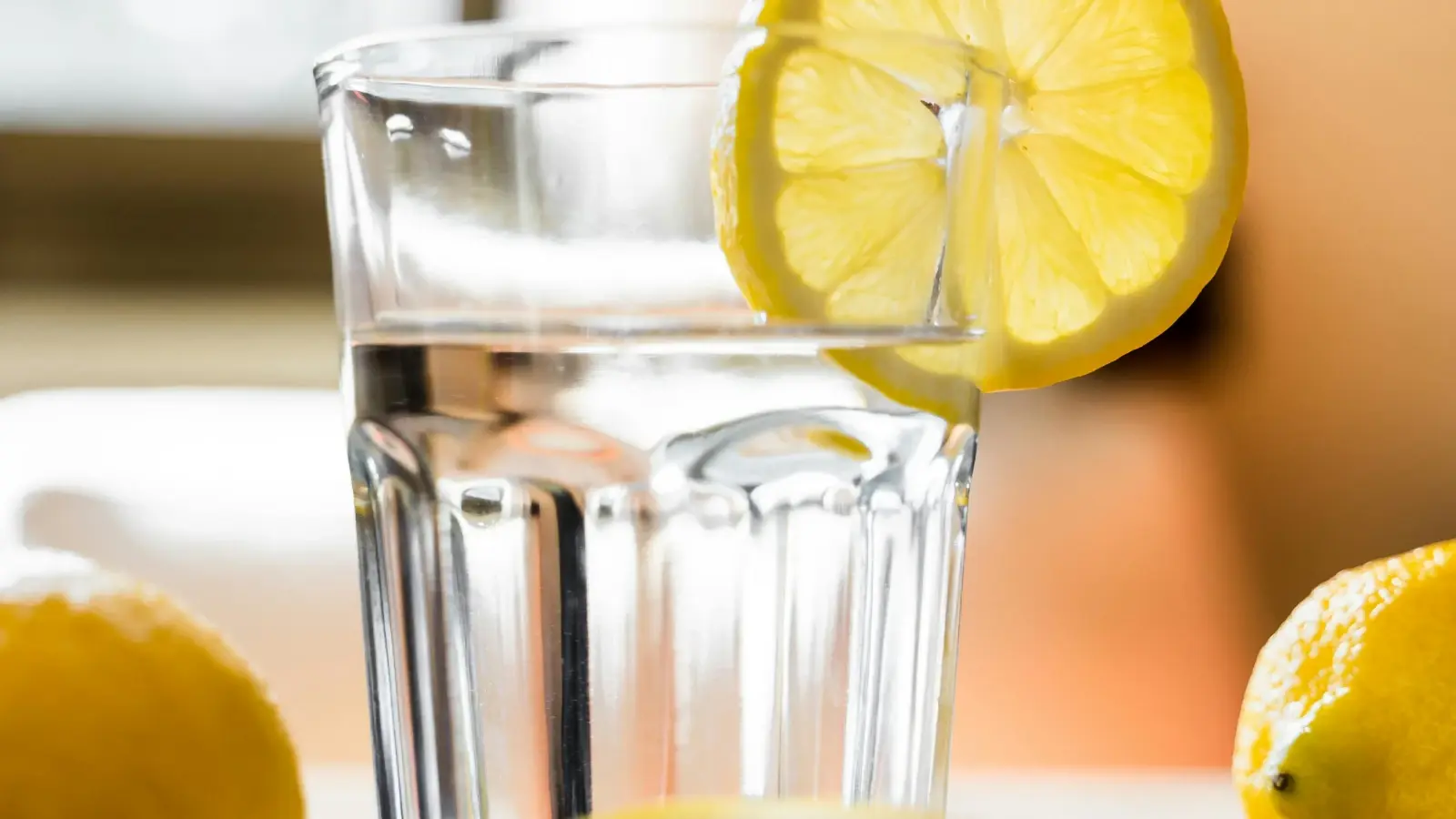 A glass of water with a slice of lemon