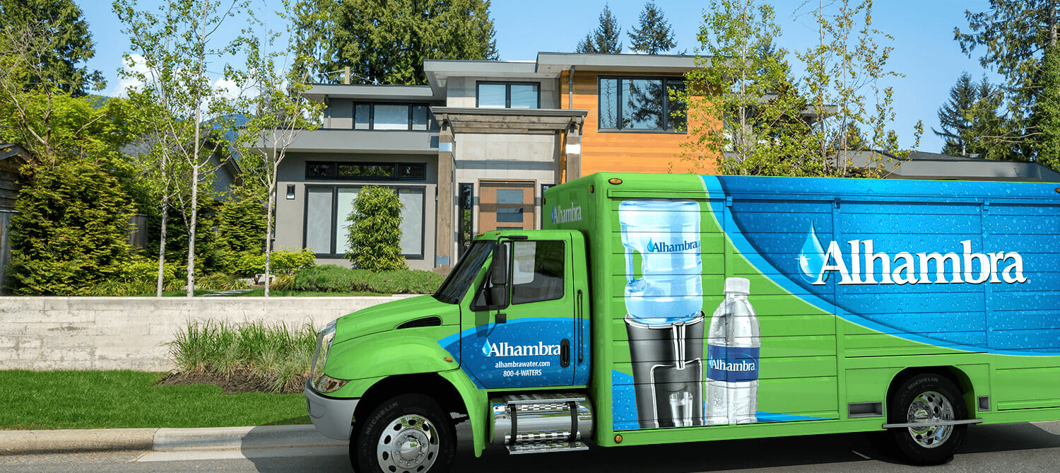 Alhambra Water Delivery Truck zoomed in on truck cab featuring Alhambra logo