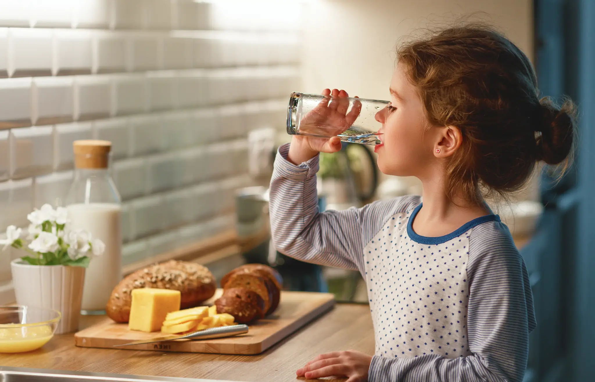 A child enjoying a refreshing glass of water