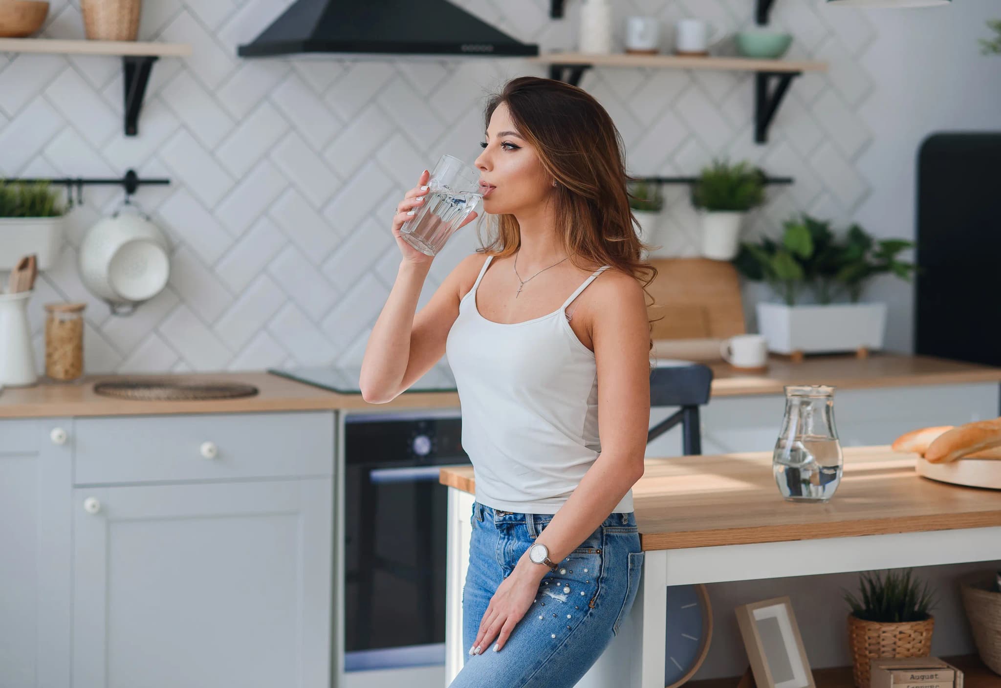 A woman drinking a glass of water