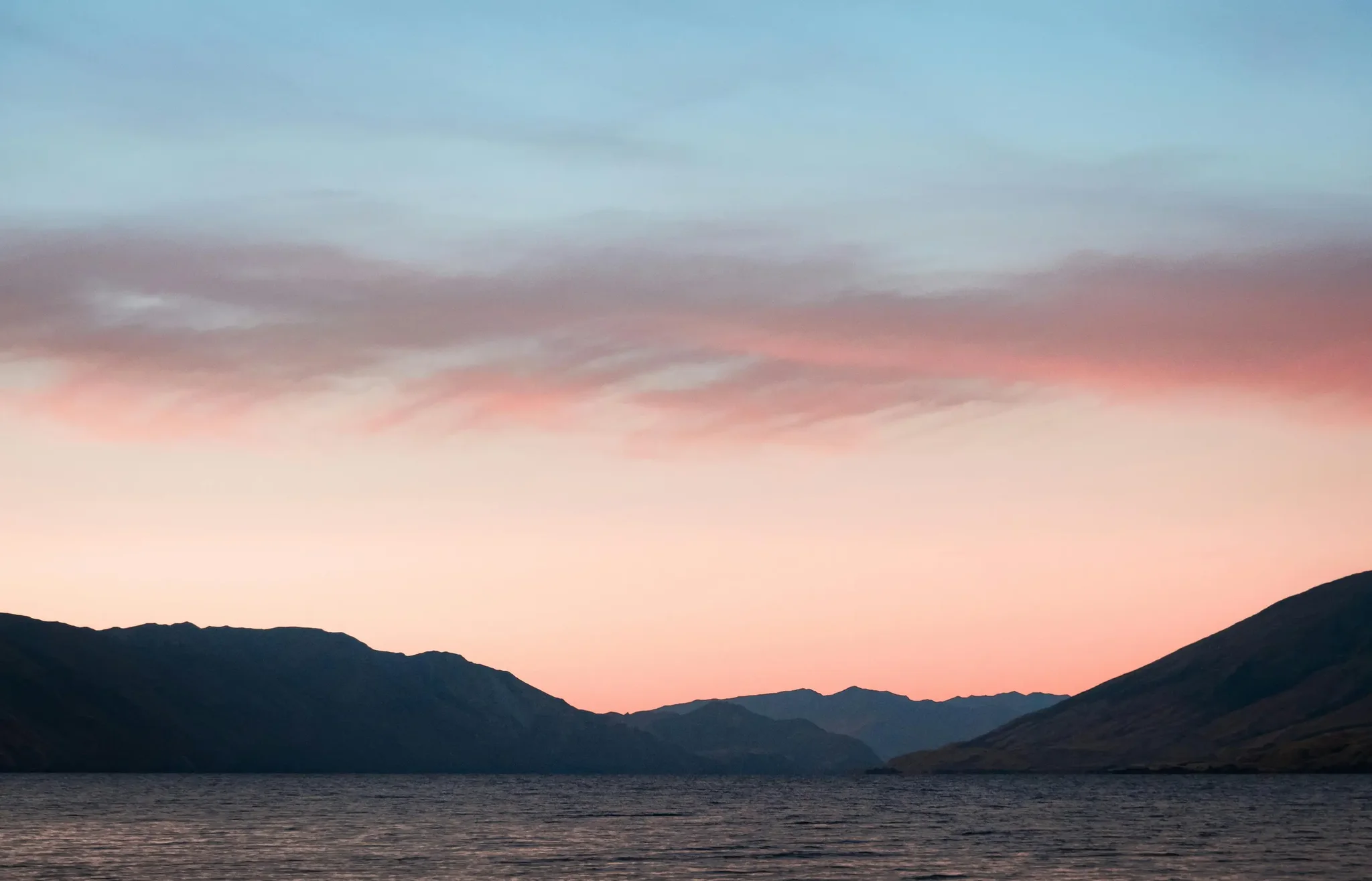 Sunset over mountains and water